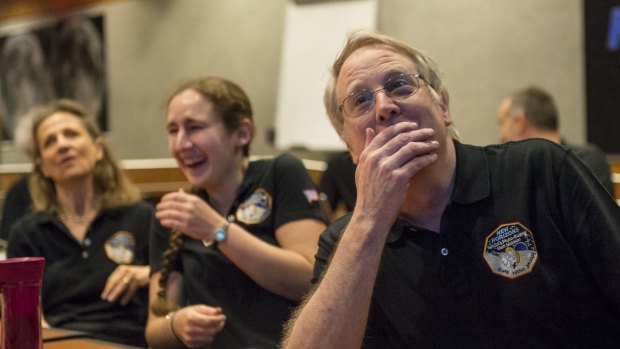 Members of the New Horizons science team react to seeing the spacecraft's last and sharpest image of Pluto.