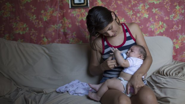 Angelica Pereira feeds her daughter Luiza, who was born with microcephaly in Santa Cruz do Capibaribe, Brazil.