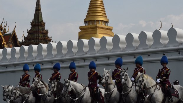 Palace guards outside the Grand Palace in Bangkok wait for the body of King Bhumibol to arrive.