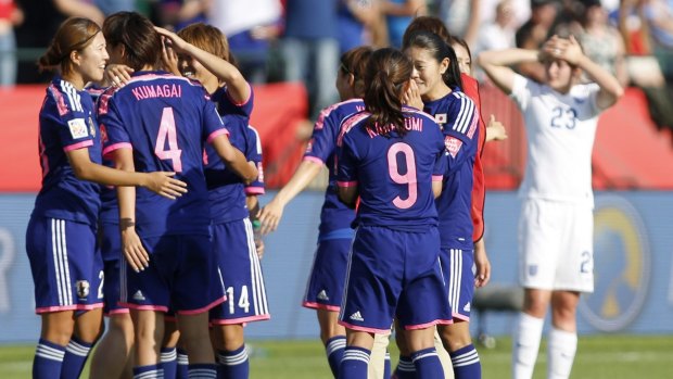 Japan's players celebrate after a 2-1 semi-final win over England.