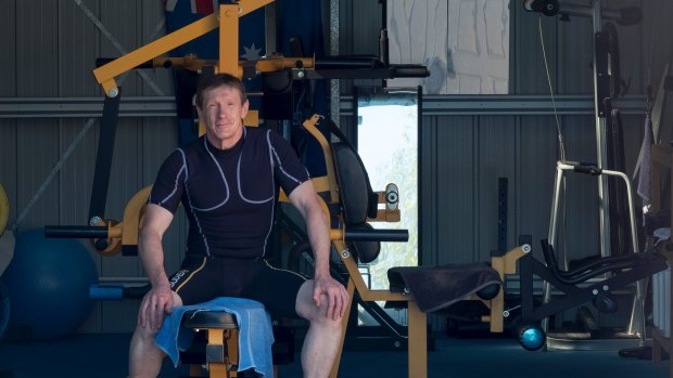 Photo of Andy Harrison at his shed which he converted to a gym.