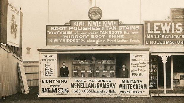Kiwi shoe polish founders William Ramsay (left) and Hamilton McKellan in the first Kiwi shop in Elizabeth Street, Melbourne, in 1909 with a billboard of arch rival Nugget brand at upper left.