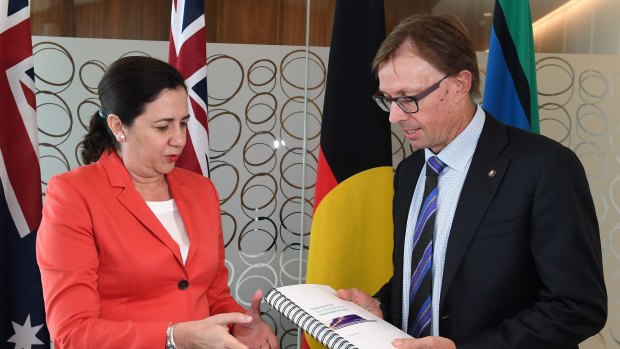 Premier Annastacia Palaszczuk receives the report from Phillip Strachan.