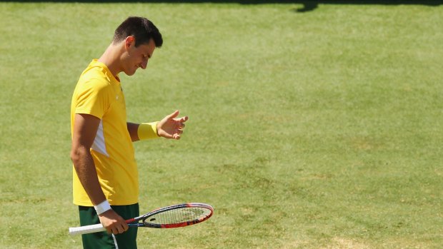 An embarrassment: Bernard Tomic on his way to losing his Davis Cup singles match against American John Isner.
