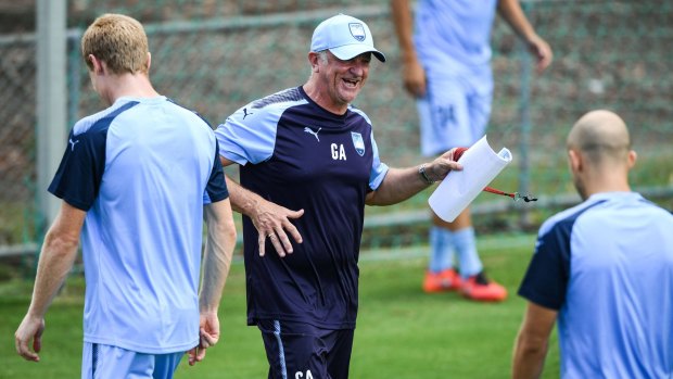Sydney FC coach Graham Arnold smiles during team training at Macquarie University on Tuesday.