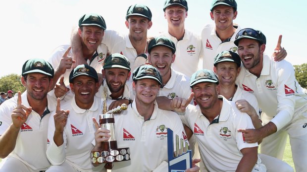 On top of the world: The Australian team celebrate with the Trans Tasman Trophy on day five of the Test match against New Zealand at Hagley Oval.