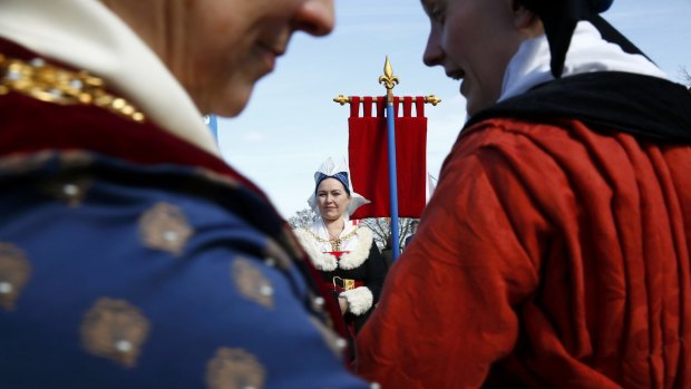 Re-enactors in period costume await the arrival of Richard III's reburial procession near Leicester in the English Midlands on Sunday.