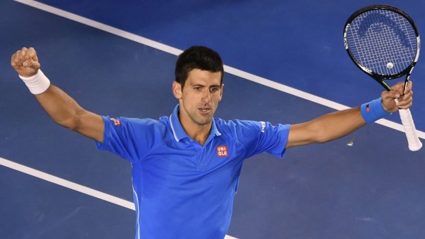 Serbia's Novak Djokovic gestures as he celebrates his victory.
