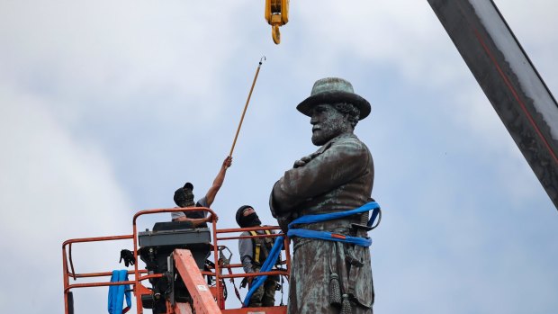 Workers prepare to take down the statue of former Confederate General Robert E. Lee in New Orleans in May.