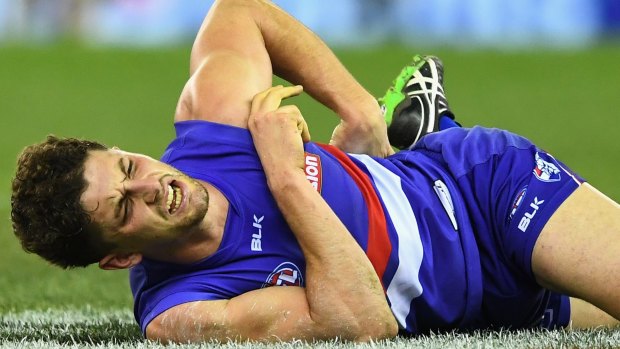 Ouch: Tom Liberatore squirms in agony.