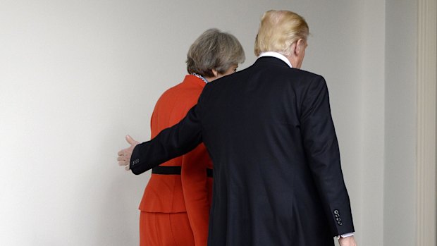 Trump walks with May outside of the White House.