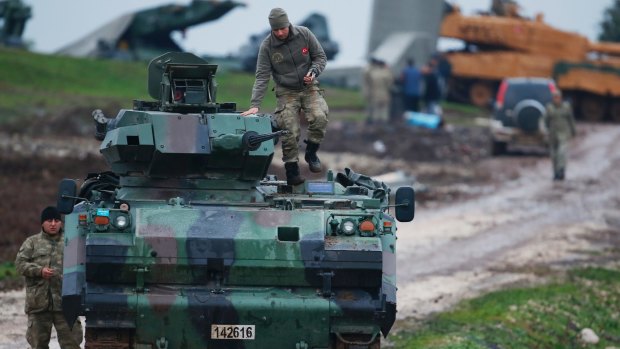 Turkish troops prepare their tanks to enter combat in Afrin, Syria.