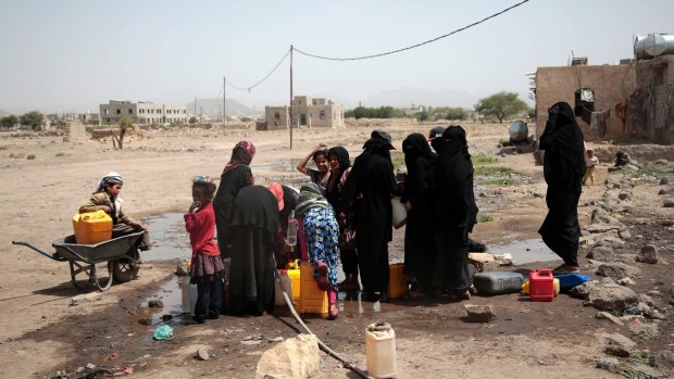 People fill buckets with water from a well that is alleged to be contaminated water with the bacterium Vibrio cholera, on the outskirts of Sanaa, Yemen.