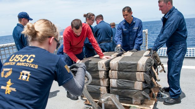 US Coast Guard crew members secure cocaine bales from a self-propelled semi-submersible in international waters off the coast of Central America last month.