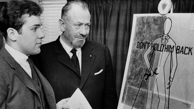 Nobel prize-winning author John Steinbeck, right, admires a prize-winning poster by his son, Thomas Steinbeck.