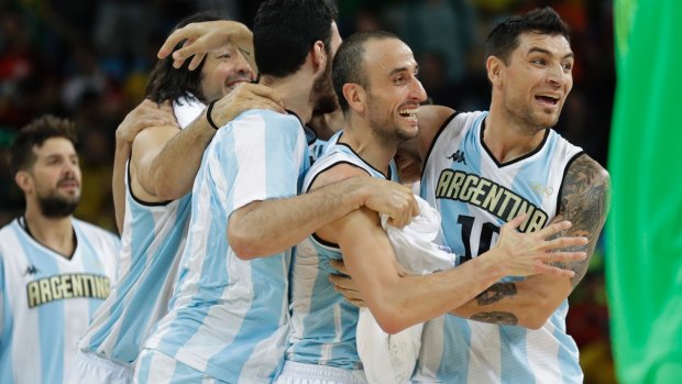 Argentina's Manu Ginobili, center, and Argentina's Carlos Delfino, right, celebrate with teammates after their win over Brazil.