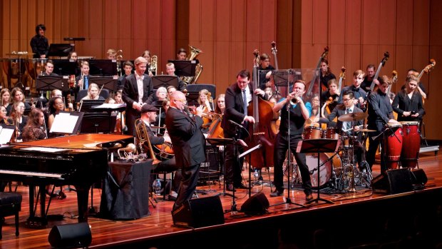 James Morrison, standing centre left, Zach Raffan, standing centre right, soloists and the Canberra Youth Orchestra perform at Llewellyn Hall. 