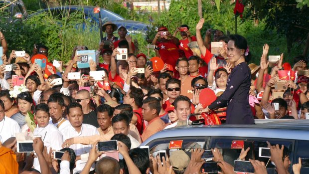 Aung San Suu Kyi greets supporters at a campaign rally on November 1 in Yangon.