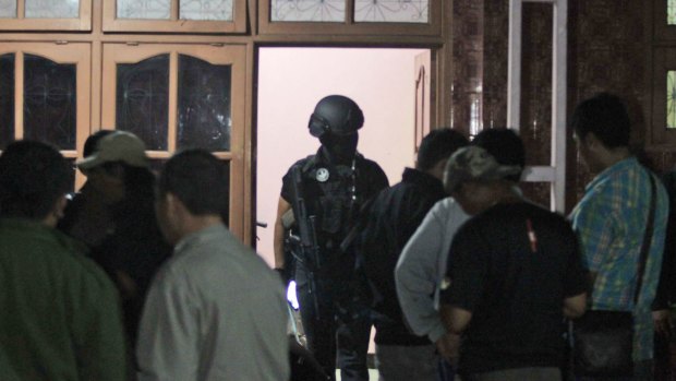 Indonesian police officers from the Special Detachment 88 anti-terror unit raid a hideout used by suspected militants.
