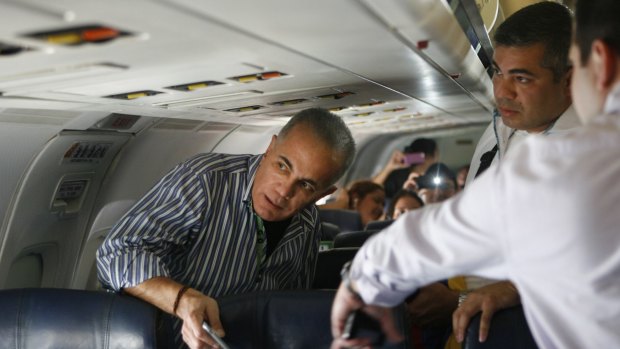 Venezuelan opposition leader Manuel Rosales, left, gets ready to leave a plane landing in Venezuela last week. He was arrested at the airport.