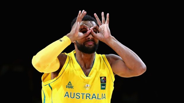 Three goggles: Patty Mills celebrates in his own inimitable style after scoring against New Zealand.