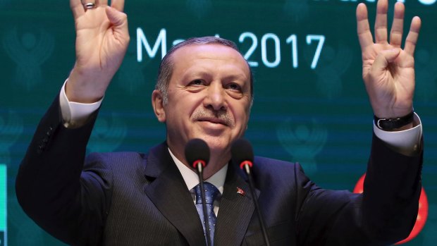 Tensions rise as political rallies in Germany cancelled: Turkey's President Recep Tayyip Erdogan addresses a meeting in Istanbul.