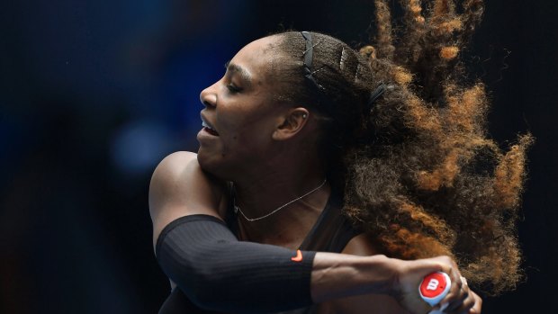 Serena Williams' hair flies en route to her first-round win against Switzerland's Belinda Bencic.