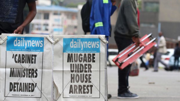 People pass a newsstand in Harare.