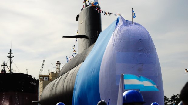 Workers stand around the ARA San Juan submarine during a ceremony celebrating the first stage of major repairs at the Argentine Industrial Naval Complex (CINAR) in Buenos Aires in 2011.