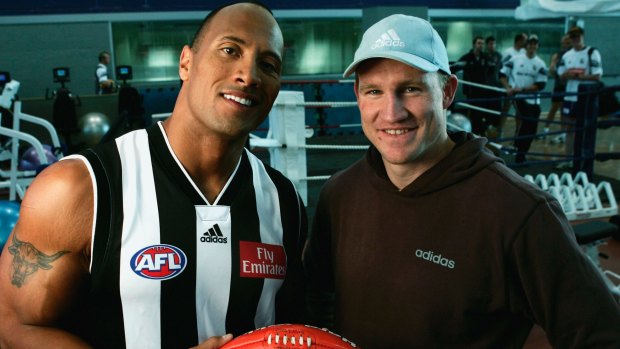 Dwayne "The Rock" Johnson meets Collingwood captain Nathan Buckley during a visit to the the Collingwood Football Club in 2004. 