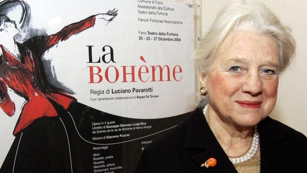 Puccini's grandaughter, Simonetta, poses in front of the poster of <i>La Boheme</i>.