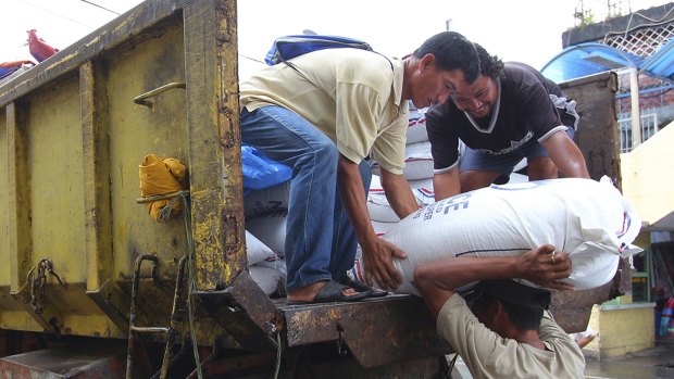 Workers unload sacks of rice intended for typhoon evacuees in Legazpi city, central Philippines.