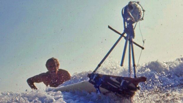 Filmmaker Bruce Brown tries to control a surfboard with a mounted camera while making a movie in 1963.