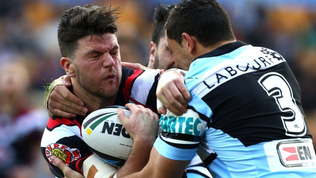 Stopped in his tracks: Warrior Chad Townsend is met by Cronulla's Jonathon Wright.