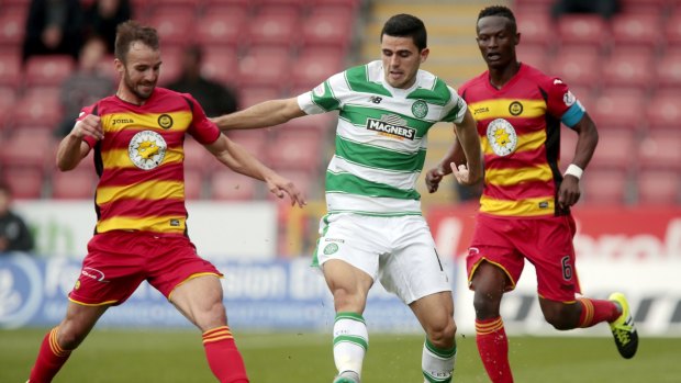Evasive: Tom Rogic gets away from Thistle's Sean Welsh and Abdul Osman.