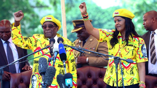 Robert Mugabe and his wife Grace chant the party's slogan during a solidarity rally in Harare on November 8.