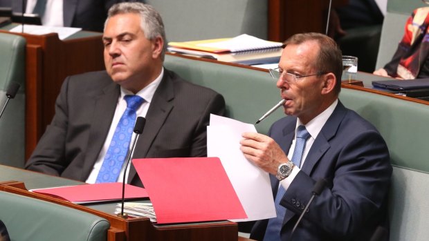 Backbenchers Tony Abbott and Joe Hockey stay on top of the paperwork during question time.