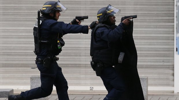 Police during the siege in Saint-Denis on Wednesday. At least two people were killed in the operation.