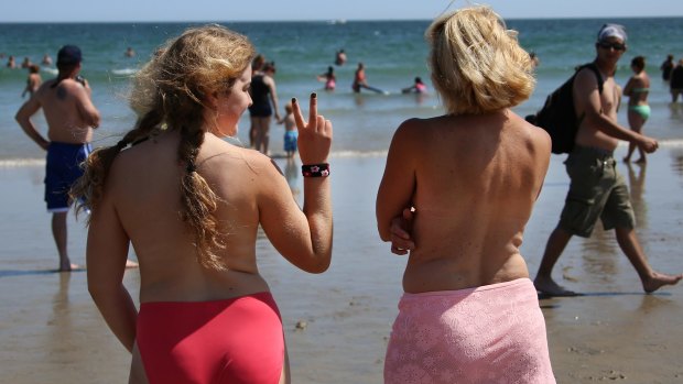 Women go topless on Hampton Beach, New Hampshire, for GoTopless Day in August. The US national day promotes gender equality and women's rights to bare their breasts in public.