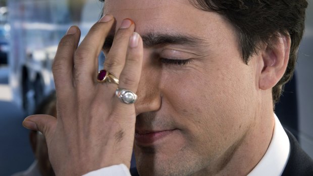 Canadian Liberal Leader Justin Trudeau receives a traditional Hindu "bindi" decoration on his forehead as a welcoming gesture at the Sanatan Mandir Cultural Centre in Markham, Ontario, on Friday.  Canadians will go to the polls in the federal election on Monday.