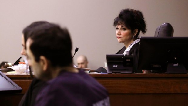 Judge Rosemarie Aquilina looks towards Larry Nassar as a victim gives her impact statement.