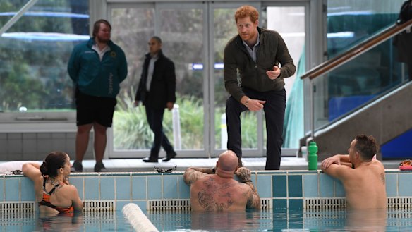 Prince Harry meets defence veteran swimmers after touring the Sydney International Aquatic Centre, where the Invictus Games will be held in 2018.
