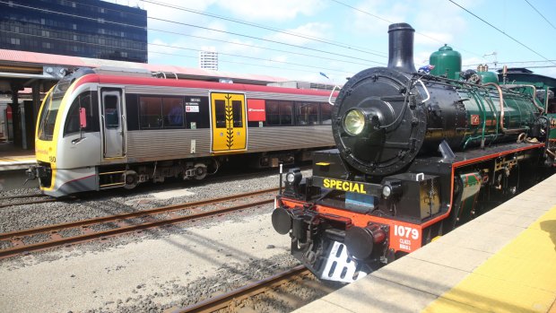 Betty the steam engine at Roma Street Station, next to a modern QR train.