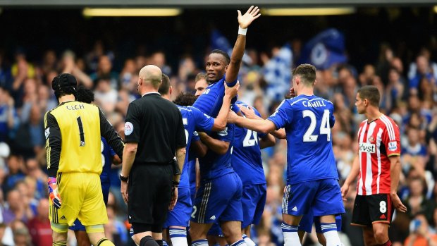 Hail to the king: Didier Drogba is chaired off by his team mates.