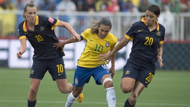 Australia's Emily Van Egmond (left) and Samantha Kerr battle with Brazil's Marta during the Women's World Cup game in Moncton on Sunday.