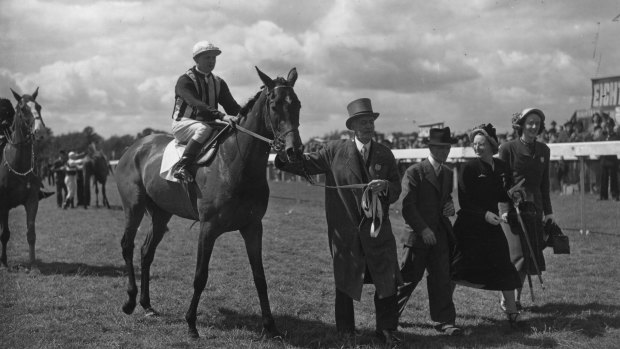 Edgar Britt on Musidona, being led in by owner N Donaldson, after winning the Oaks Stakes, 1949.