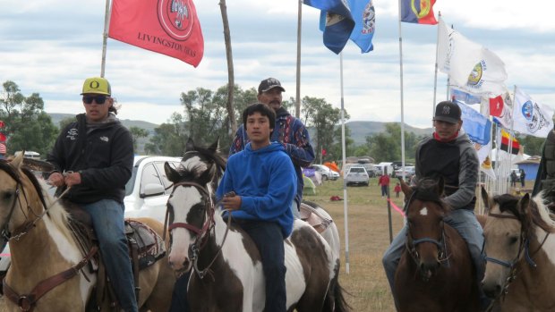 Horseback riders make their way through an encampment near North Dakota's Standing Rock Sioux reservation. The tribe says the project will disturb sacred sites and impact drinking water.
