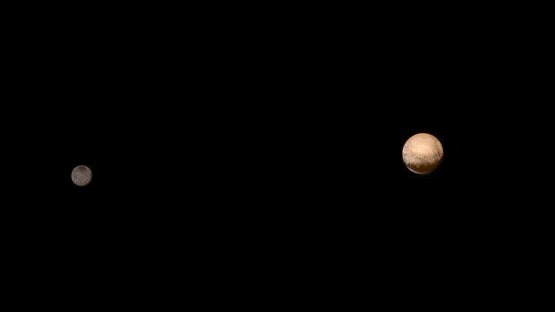 Pluto (right) and its moon Charon are pictured from about 6 million kilometres in this July 8 NASA handout photo.