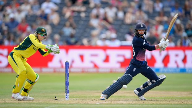 Cover drive: England's Danielle Wyatt hits out in front of Australian wicketkeeper Alyssa Healy.