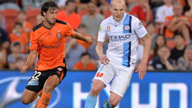 Aaron Mooy of Melbourne City breaks away from his marker Thomas Broich of the Roar.